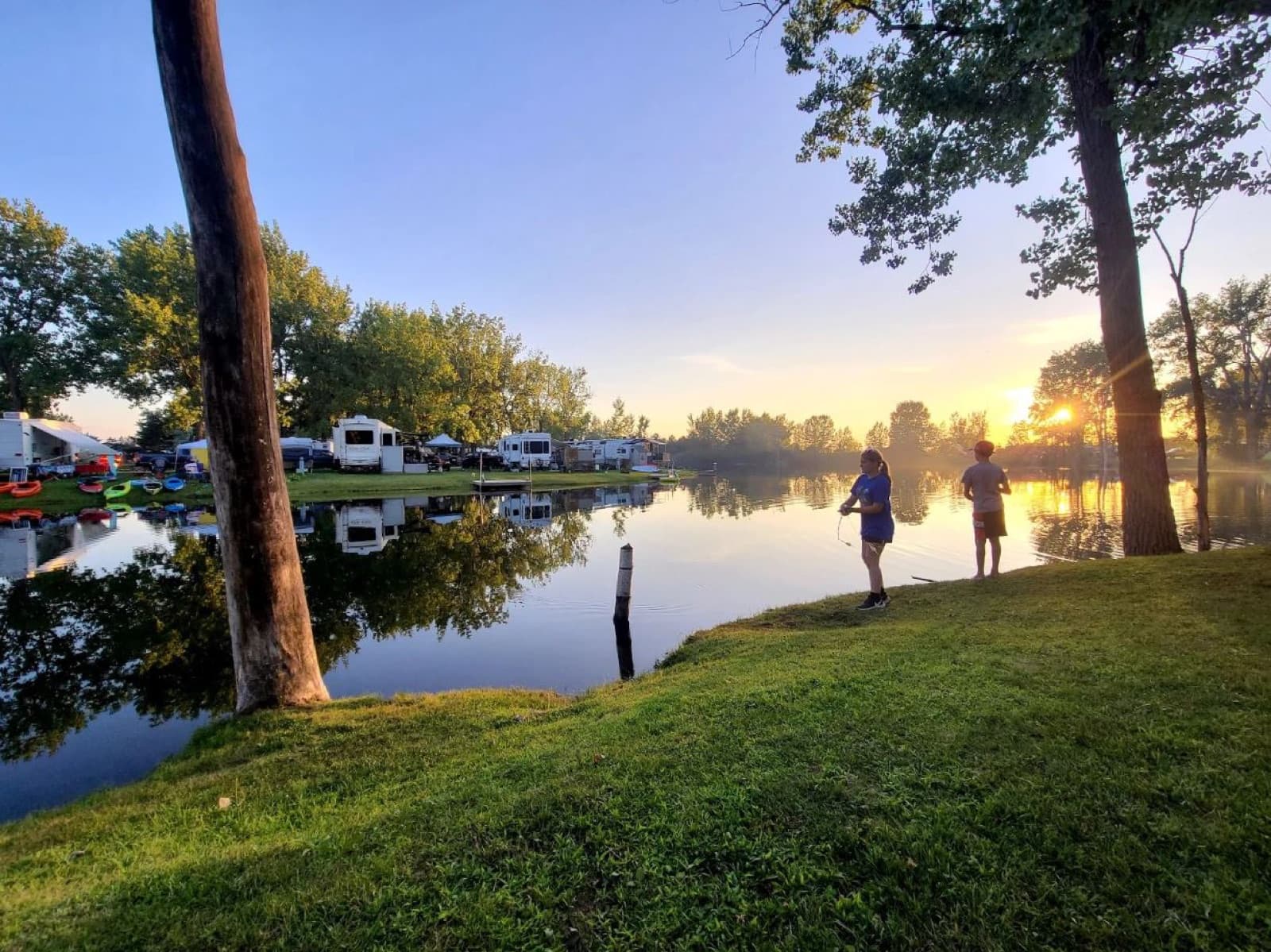 Guests fishing at golden hour beside the lake at Krystal Lake